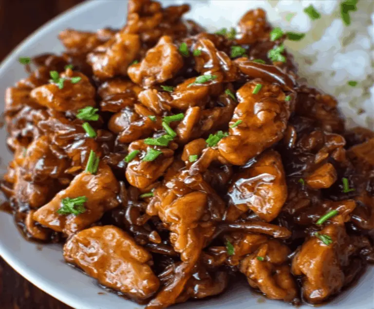 Delicious Crock Pot Bourbon Chicken served with rice and vegetables, featuring tender, flavorful chicken cooked in a rich bourbon sauce