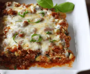 Delicious zucchini pizza casserole with melted cheese, fresh tomatoes, and herbs in a baking dish, ready to serve
