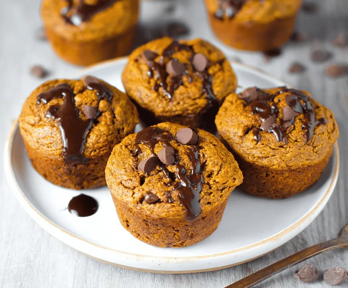 Delicious healthy flourless pumpkin muffins topped with a sprinkle of cinnamon on a white plate