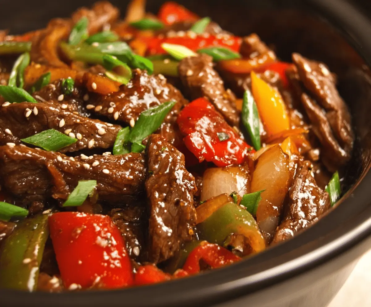 Delicious pepper steak cooking in a Crock Pot, featuring tender beef slices, colorful bell peppers, and savory sauce, perfect for a hearty slow cooker meal.