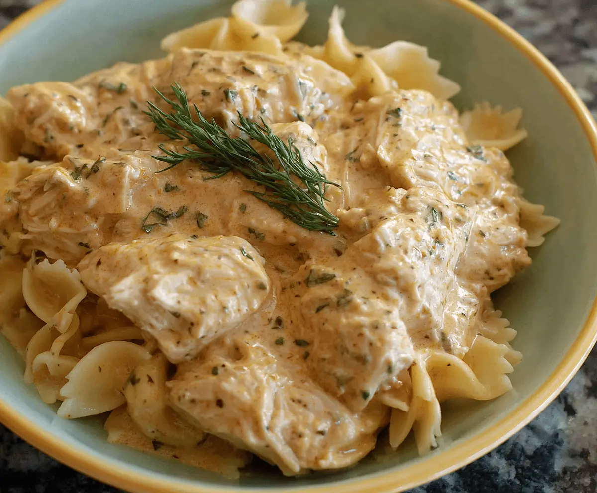 Creamy Ranch Chicken cooked in a Crockpot served with fresh herbs and vegetables, perfect for a flavorful and easy dinner