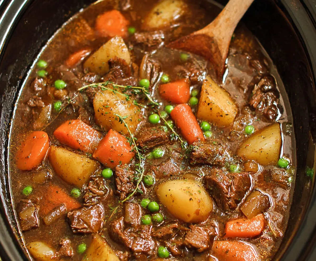 Delicious beef stew cooking in a crock pot, perfect for a hearty meal.